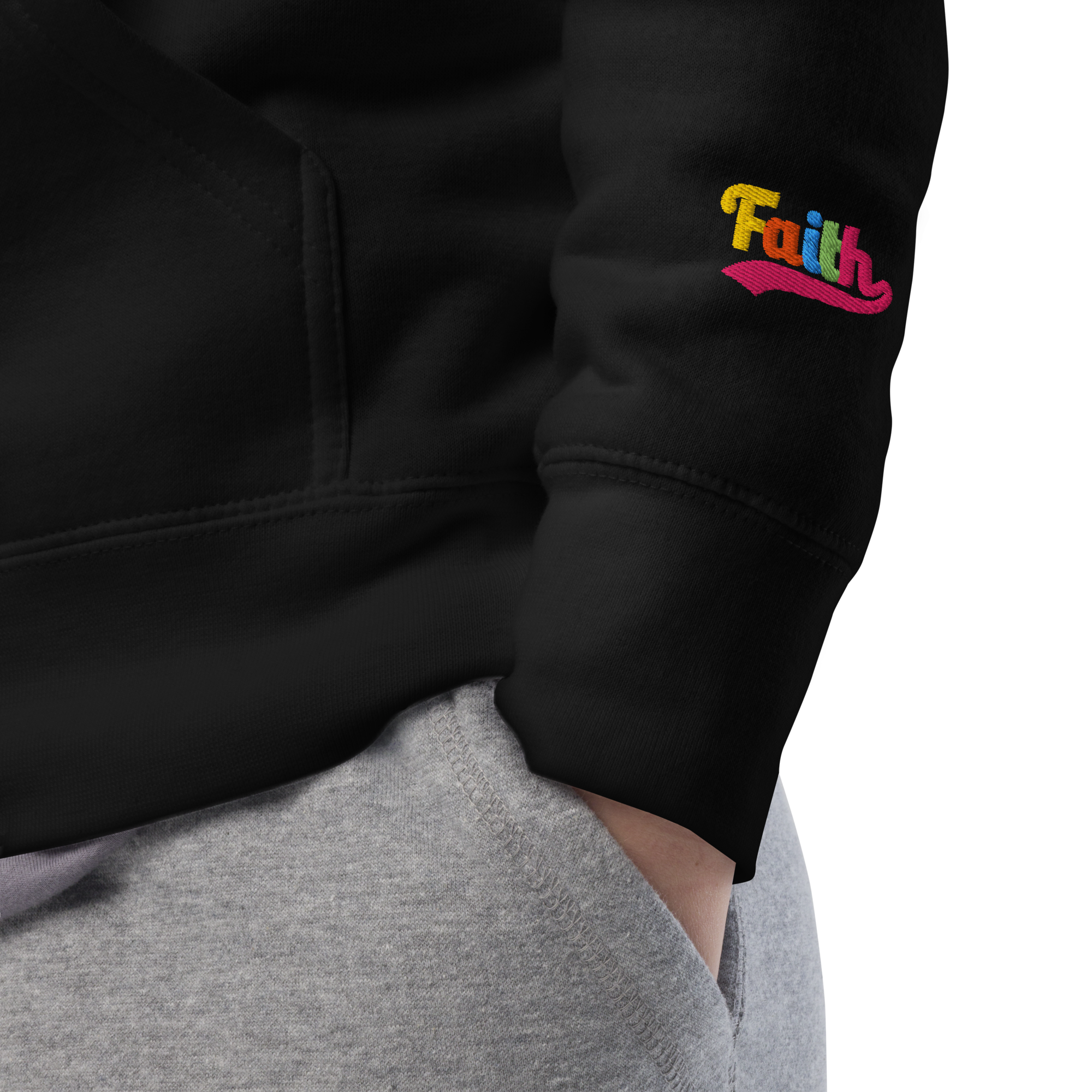 black hoodie with 'Faith' embroidered on the sleeve, worn by a person.