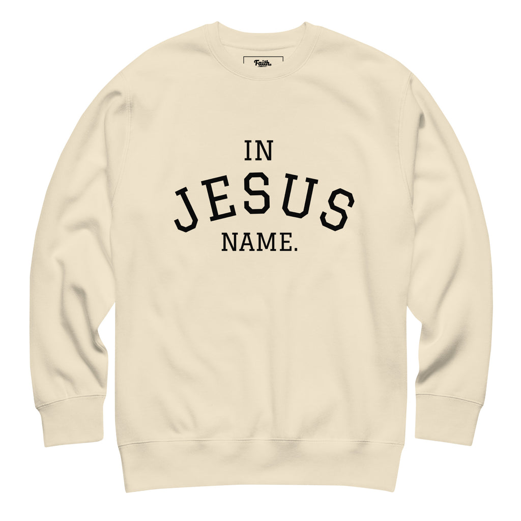 Beige sweatshirt with 'IN JESUS NAME' text 